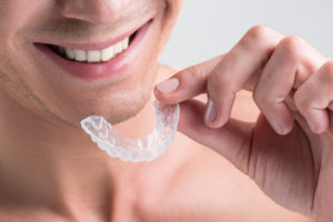 Man holding Invisalign